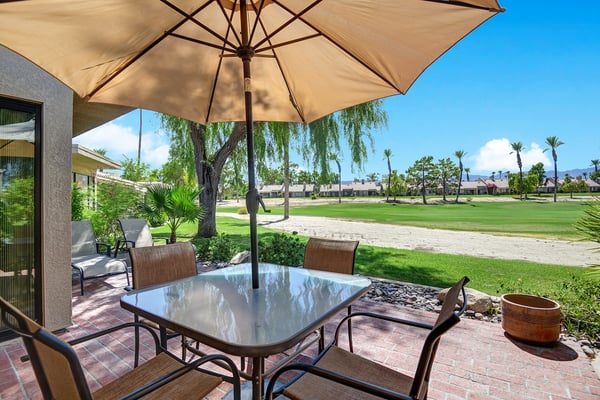 Your private patio overlooks lush fairways and swaying palms, inviting you to savor morning coffee or evening cocktails in the warm desert breeze.