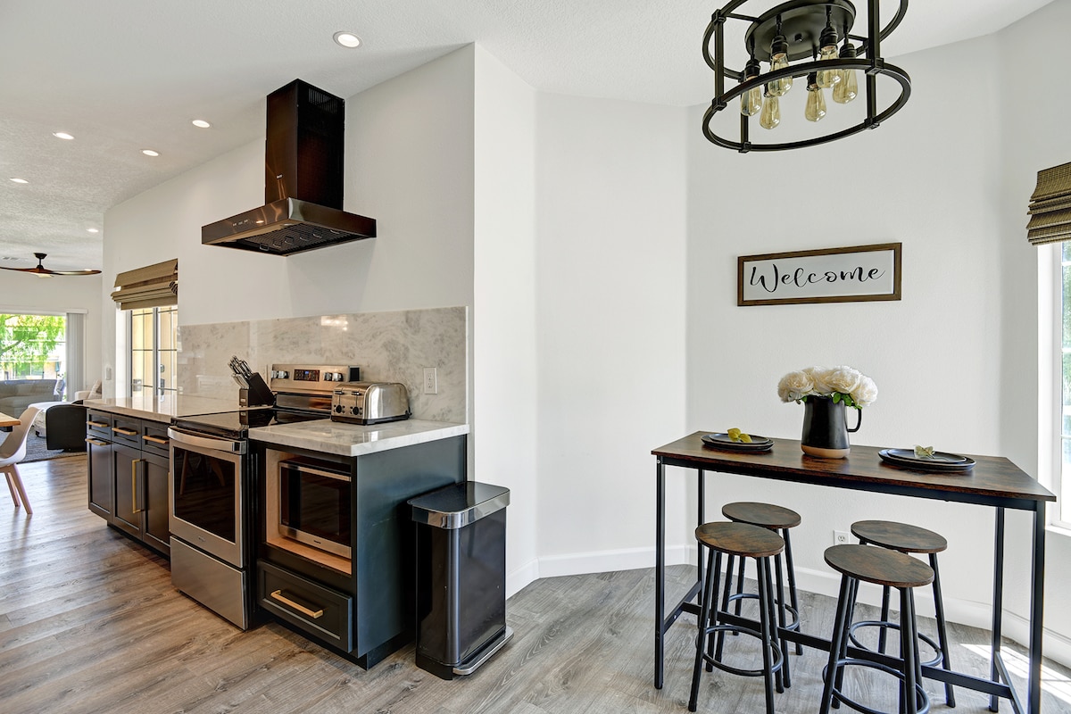 Step into your bright, modern kitchen where stainless appliances and sleek counters make cooking a breeze. Gather around the cozy breakfast bar for morning coffee or evening conversation—every meal feels special here.