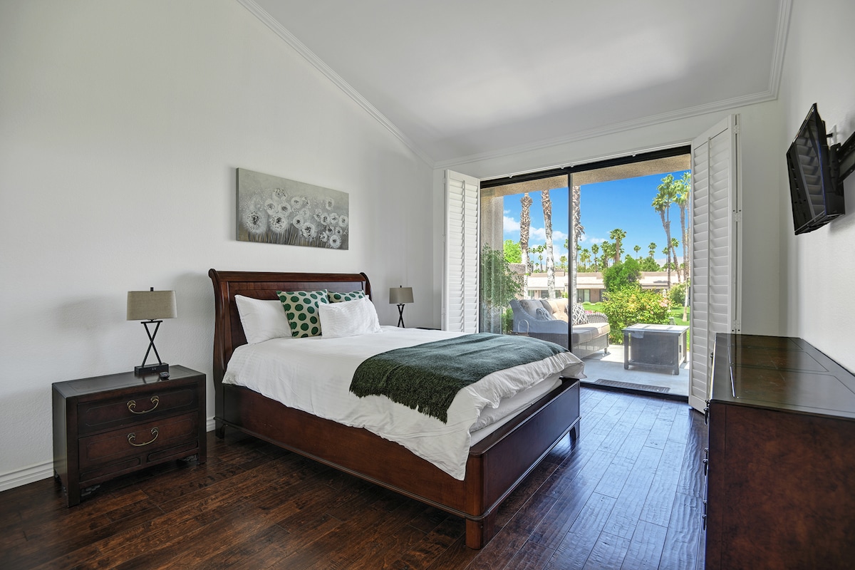 Wake up to brilliant sunshine and swaying palm trees just beyond your private balcony. This bright bedroom invites you to unwind in crisp linens and start each day immersed in warm desert charm.