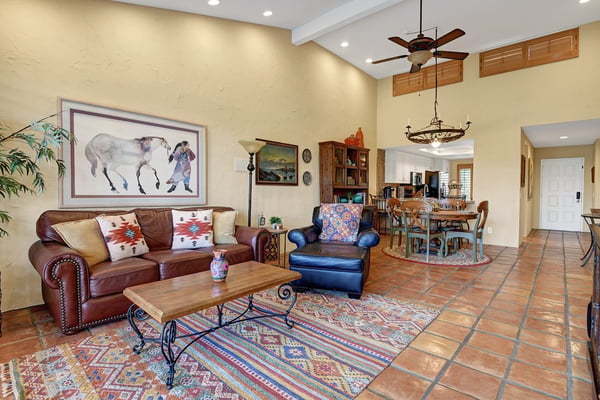 Settle into your spacious living area with vaulted ceilings, southwestern charm, and comfortable seating that flows seamlessly into your dining space—perfect for relaxing after a day of adventure.