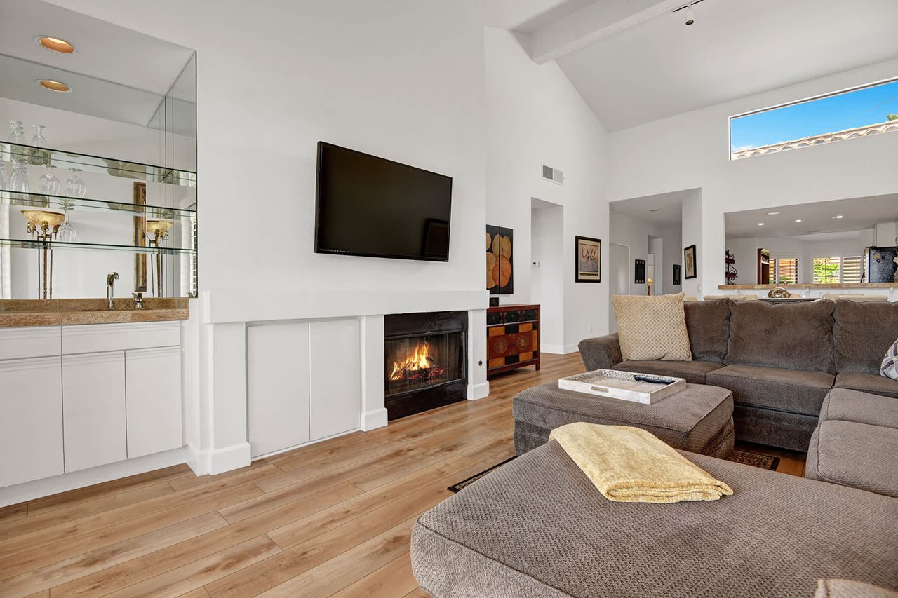 Unwind in your bright, modern living room where a warm fireplace and plush sectional await your cozy evenings in.