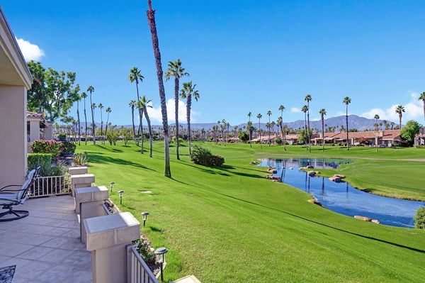 Stunning golf course and mountain views stretch before you from your private patio, where lush fairways, tranquil water features, and swaying palms create an idyllic desert escape.