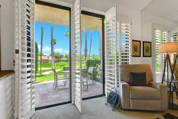 Settle into your cozy reading nook with doors opening to your private patio, where manicured lawns and swaying palms create your perfect desert retreat.