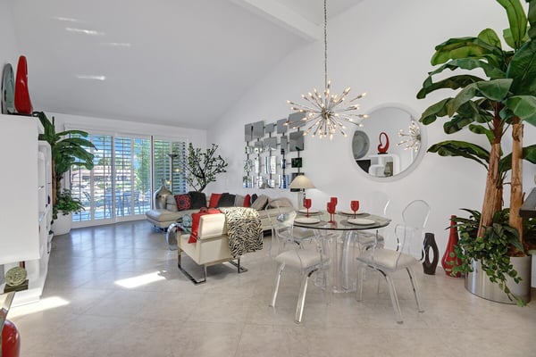 Step into your modern retreat where sleek design meets comfort. Natural light streams through plantation shutters, illuminating contemporary furnishings and striking accents in a bright, open space that feels both stylish and welcoming.