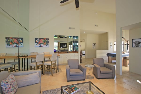 Gather in this light-filled, open-concept living space where the dining table invites conversation and the cozy seating area becomes your retreat after a day of exploring.