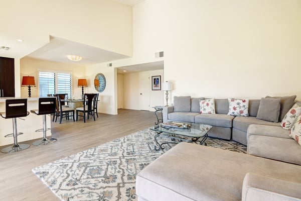 Unwind in your spacious, light-filled living room with comfortable seating and an open layout that flows into the dining area—perfect for relaxing after a day of exploring.