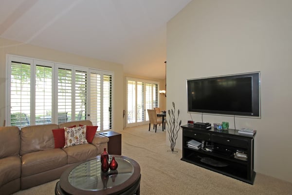 Settle into this comfortable living space where natural light pours through plantation shutters and plush seating invites you to unwind after your day's adventures.