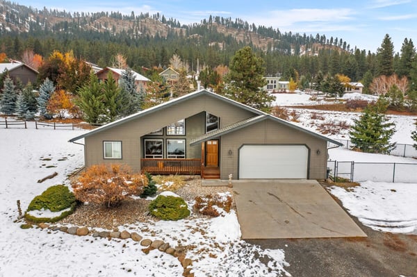 Mountain retreat surrounded by snowy landscapes and forested hillsides—a peaceful neighborhood setting perfect for those who love nature and changing seasons.