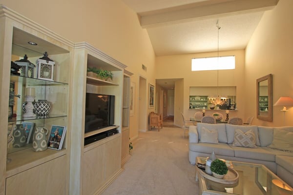 Sink into the plush sofa and unwind in this bright, open living space that flows seamlessly into your dining area and kitchen—perfect for relaxing evenings at home.