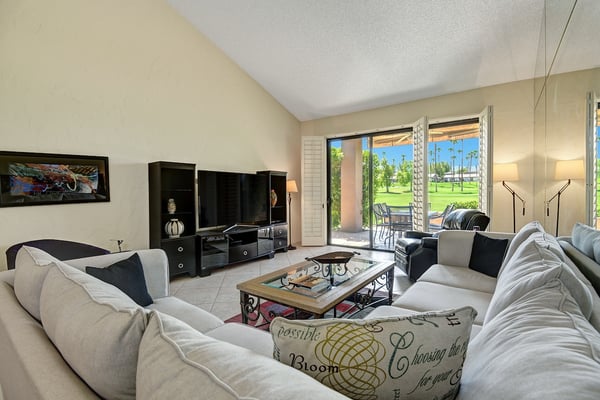 Settle into plush sofas and enjoy your favorite shows, then step through the sliding doors to your private patio overlooking lush greenery—perfect for relaxing mornings and leisurely afternoons.