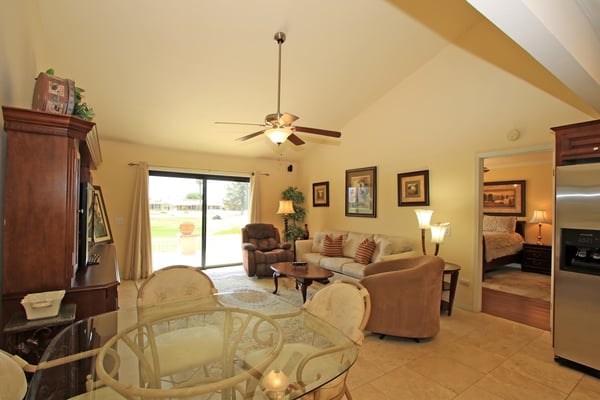 Step into your home away from home, where vaulted ceilings and warm neutral tones create an open, welcoming atmosphere. Settle into the cozy living area or enjoy meals at the charming glass-top dining table—perfect for unwinding after your day.