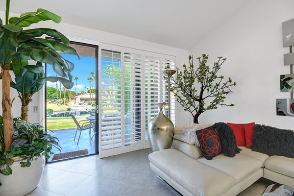 Sink into plush seating and watch sunlight stream through plantation shutters onto your private pool view. Bright, airy, and perfectly designed for your desert escape.