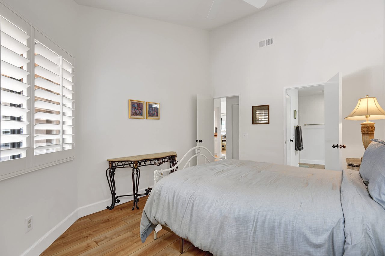 Sink into soft linens and wake to warm sunlight through plantation shutters. Your private bedroom offers peaceful tranquility with classic charm and easy access to the ensuite.