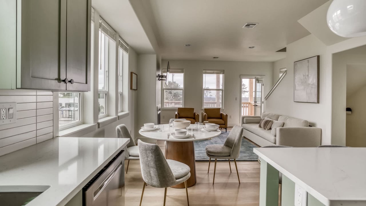 Gather around the dining table where sunlight streams through tall windows, then sink into the sofa for a quiet afternoon. Your open-concept retreat feels airy, modern, and utterly inviting.