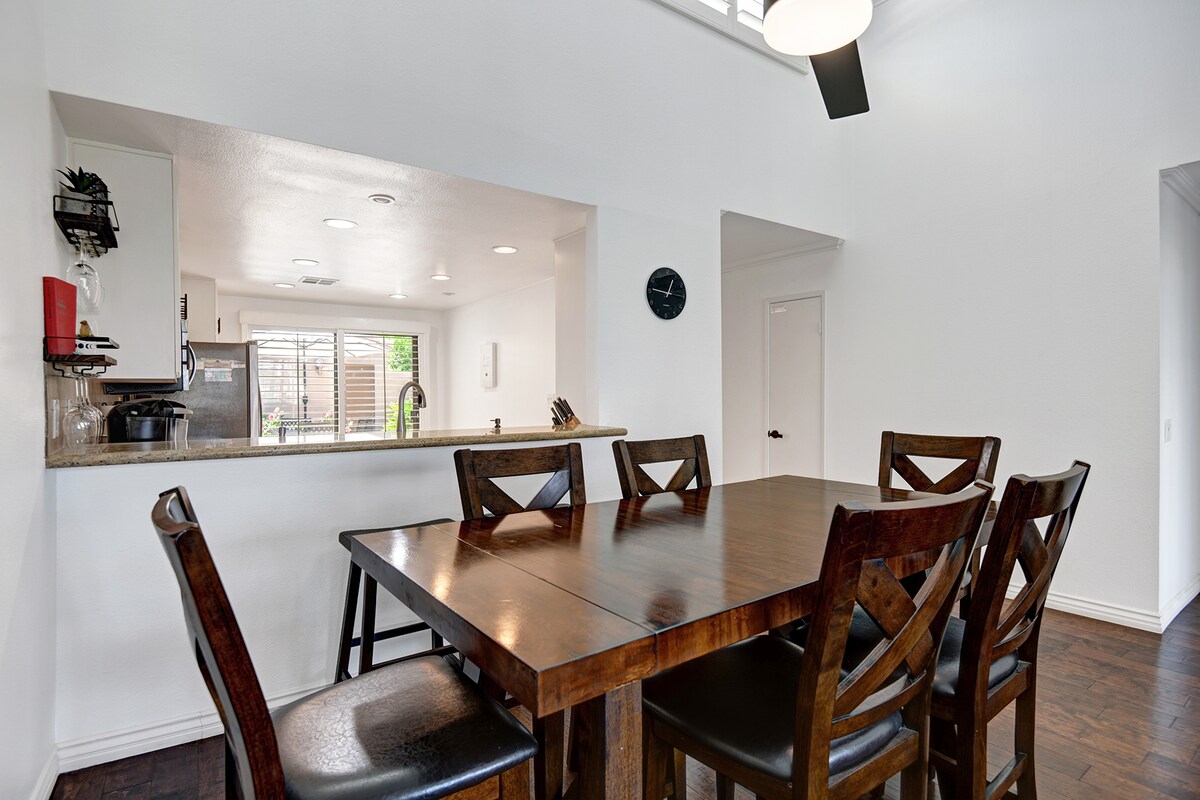 Gather around the handsome dining table with seating for six, perfectly positioned near the kitchen for easy meal service and conversation.