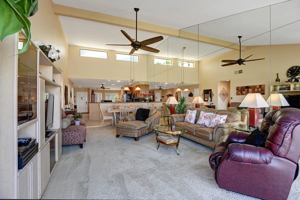 Stretch out in your spacious open-plan living area, where soaring vaulted ceilings, gentle ceiling fans, and warm natural light create a welcoming retreat after a day of exploring.