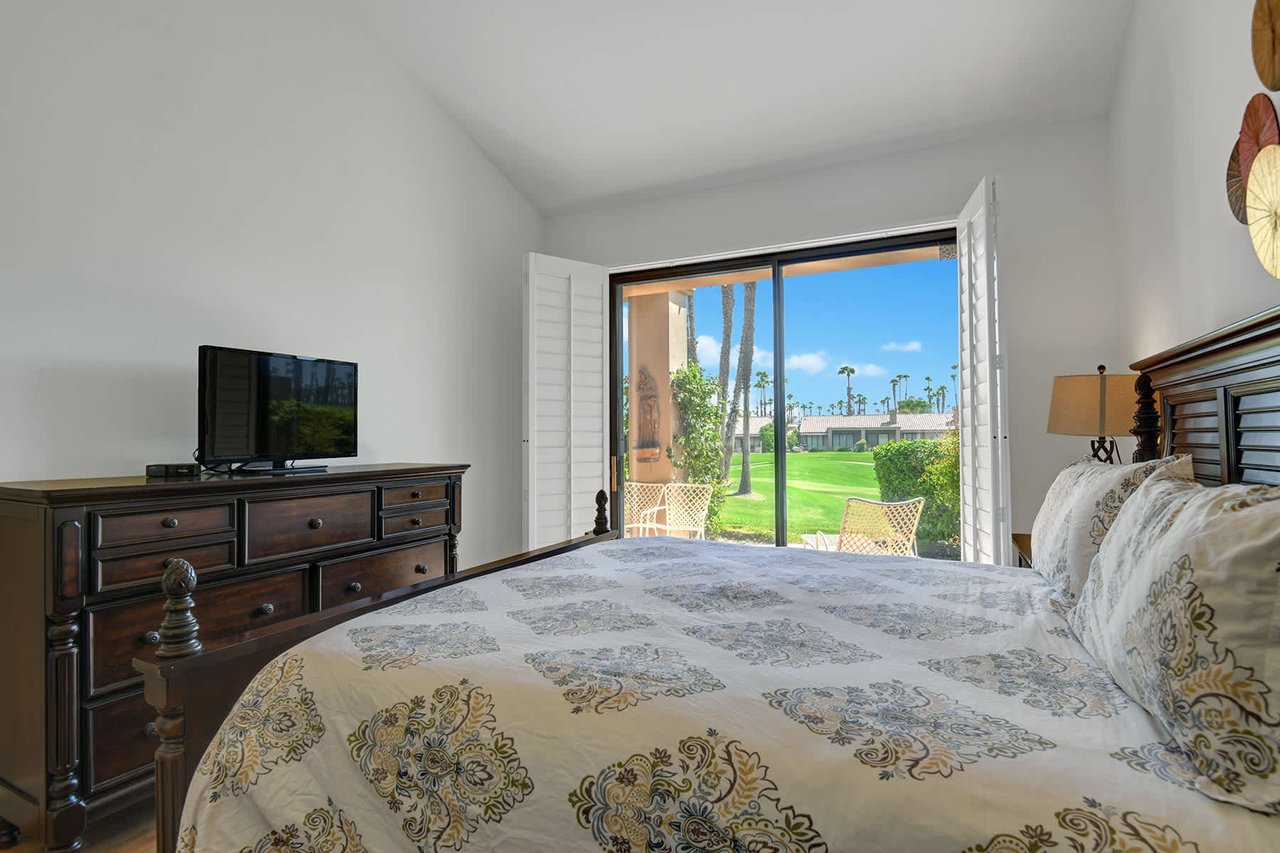 Wake up to your own private oasis. Step through open doors onto a sunlit patio, then unwind with lush greens and swaying palms just beyond your balcony.