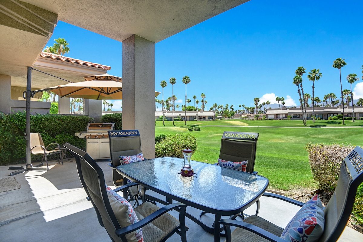 Step onto your private covered patio where morning coffee meets resort-style views. Fire up the grill, dine al fresco under the umbrella, and soak in the lush fairways and swaying palms—your perfect desert escape.