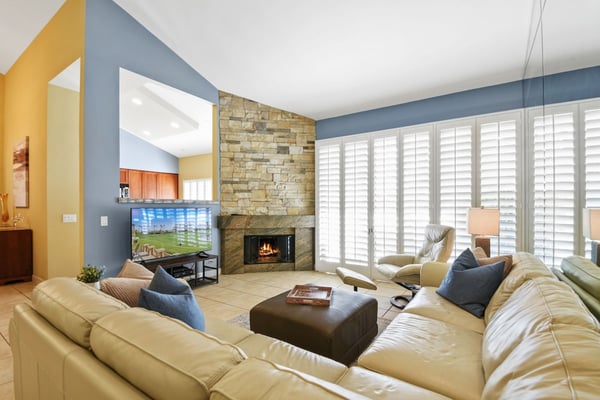 Settle into your sunlit living room where vaulted ceilings and a cozy stone fireplace create the perfect space for relaxing after a day of adventure.