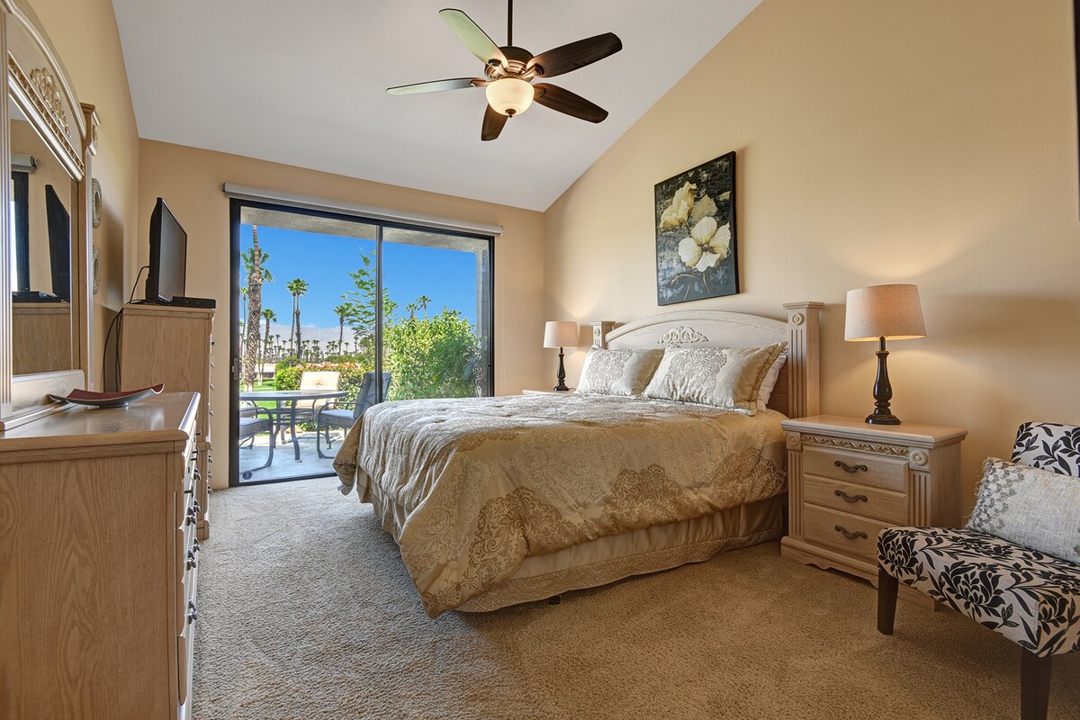 Wake up in your sunlit bedroom where palm trees sway just beyond the patio doors. Sink into the plush bed, feel the breeze from the ceiling fan, and start each morning with a view that invites you to step outside.