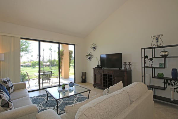 Relax in your spacious living room with comfortable seating, modern entertainment, and direct patio access overlooking lush green spaces. Perfect for unwinding after a day of adventure.