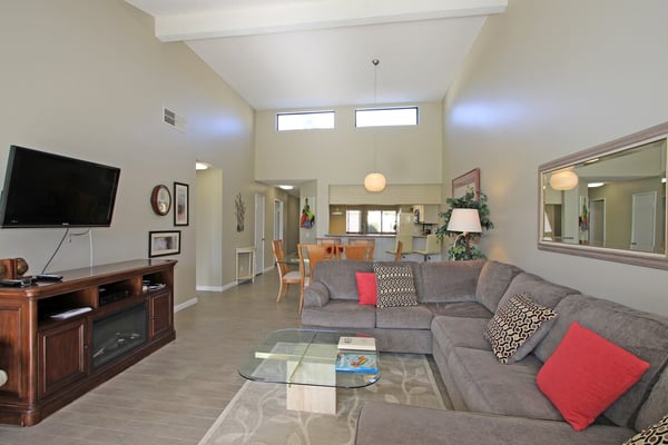 Relax in your spacious living room with high ceilings and abundant natural light streaming through clerestory windows. Sink into plush seating and unwind after your adventures.