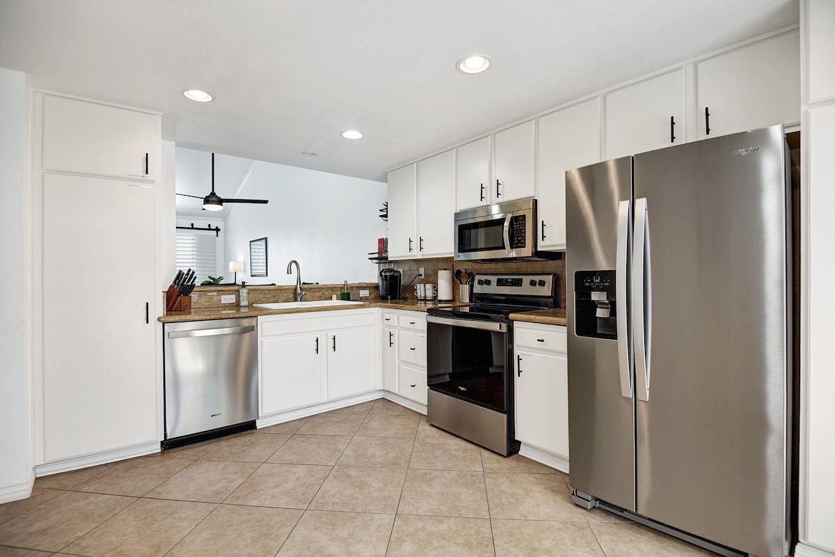 Your fully equipped kitchen makes it easy to prepare meals in style. Enjoy sleek stainless appliances, ample counter space, and bright white cabinetry in this modern, open cooking area.