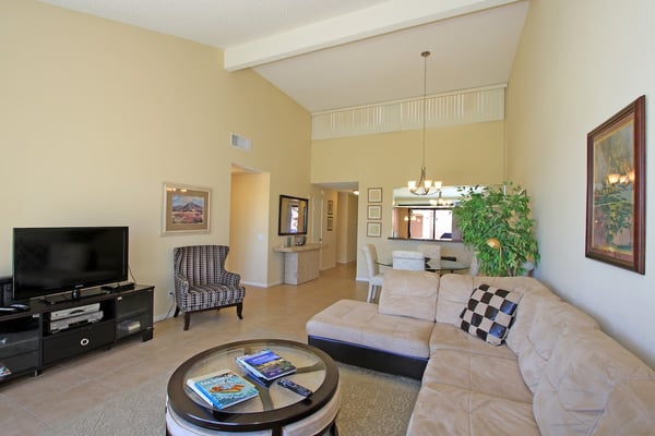 Step into your bright, open living space with vaulted ceilings and inviting furnishings—a perfect retreat to unwind after a day of desert adventures.