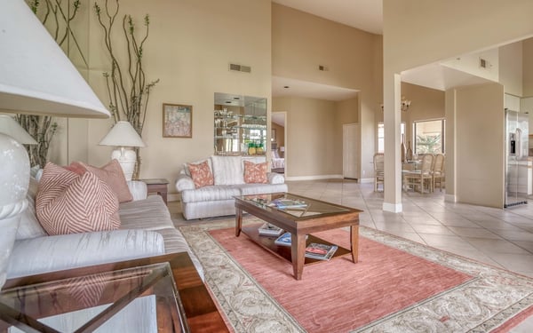 Step into your elegant living space, where soft desert tones and soaring ceilings invite you to unwind. Sink into plush sofas, gather around the coffee table, and make yourself at home in this bright, welcoming retreat.