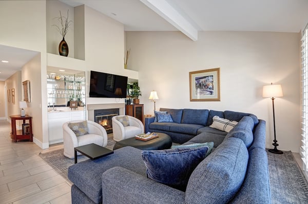 Gather in this inviting living room where vaulted ceilings and a cozy fireplace create the perfect retreat. Sink into the plush sectional and unwind—your home away from home awaits.