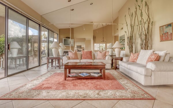 Settle into this sun-filled living room where vaulted ceilings and floor-to-ceiling windows create an airy, welcoming retreat. Sink into plush sofas and let the natural light and warm desert palette ease you into vacation mode.