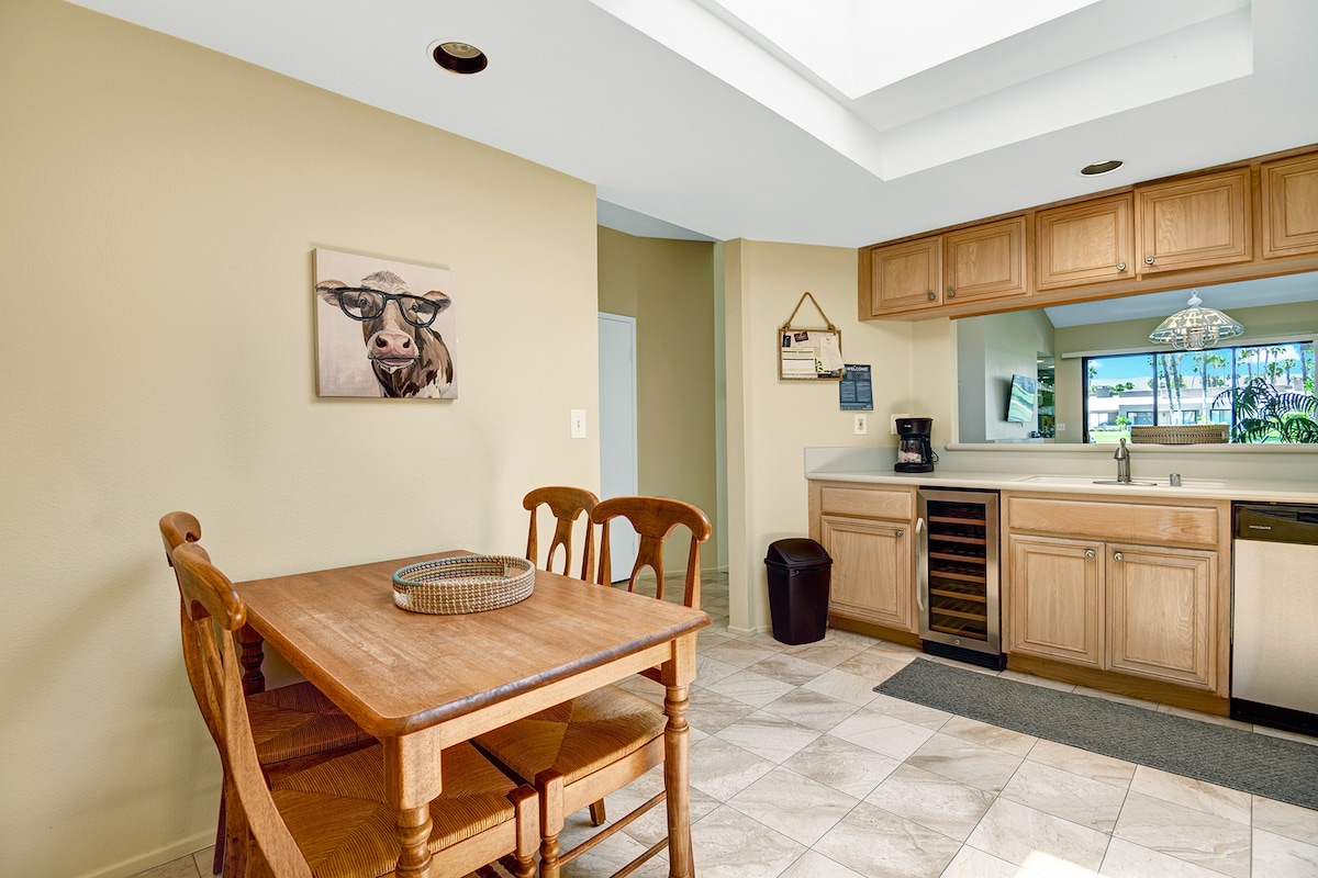 Gather around the warm wooden table for a home-cooked meal in your fully equipped kitchen, where natural light and quirky charm make every breakfast feel special.