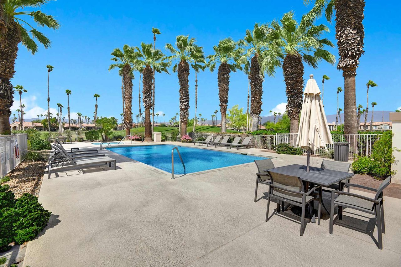A sparkling pool surrounded by swaying palms and mountain views awaits. Lounge poolside, dine at the outdoor table, or simply soak in the desert sunshine.