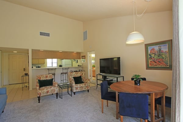 Settle into your cozy living and dining area, where vaulted ceilings create an airy atmosphere and the open layout connects you to the fully equipped kitchen—perfect for relaxed evenings in.