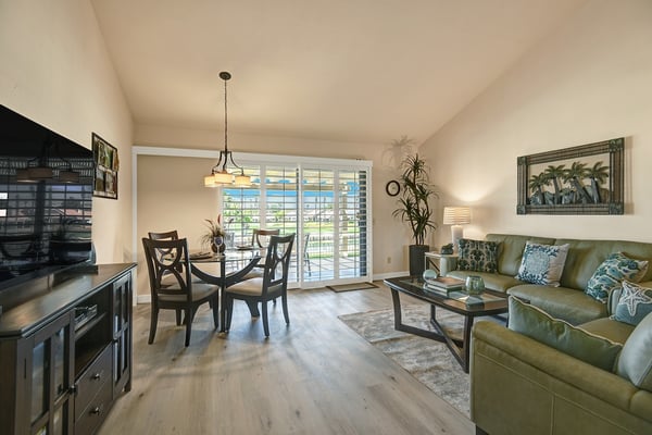 Welcoming open-concept living space with natural light, polished floors, and a seamless flow between dining and living areas—perfect for relaxing evenings.