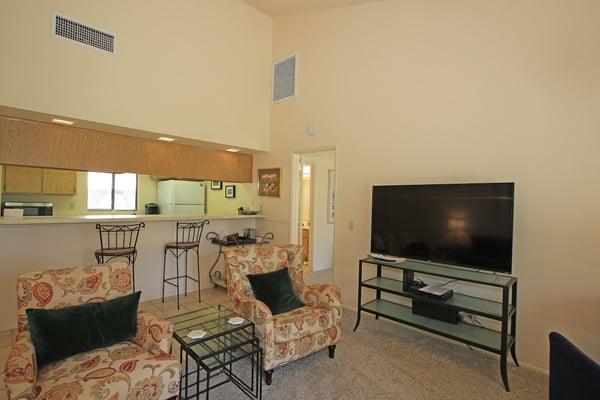 Step into your open living space with vaulted ceilings that create an airy, welcoming feel. Sink into floral armchairs after a day of adventure, while cool air-conditioning keeps you comfortable year-round.