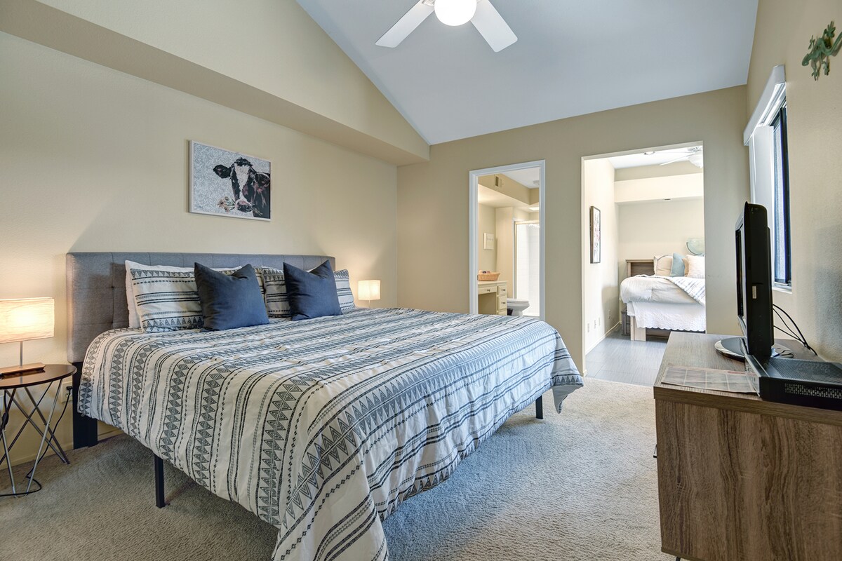 Unwind in your spacious primary bedroom, where vaulted ceilings and soft natural light create a serene retreat after a day of adventure.