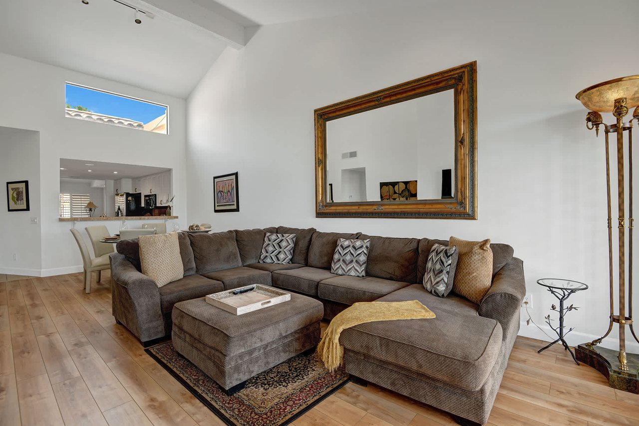 Sink into plush sofas beneath soaring ceilings and natural light, with the kitchen just steps away for your morning coffee.