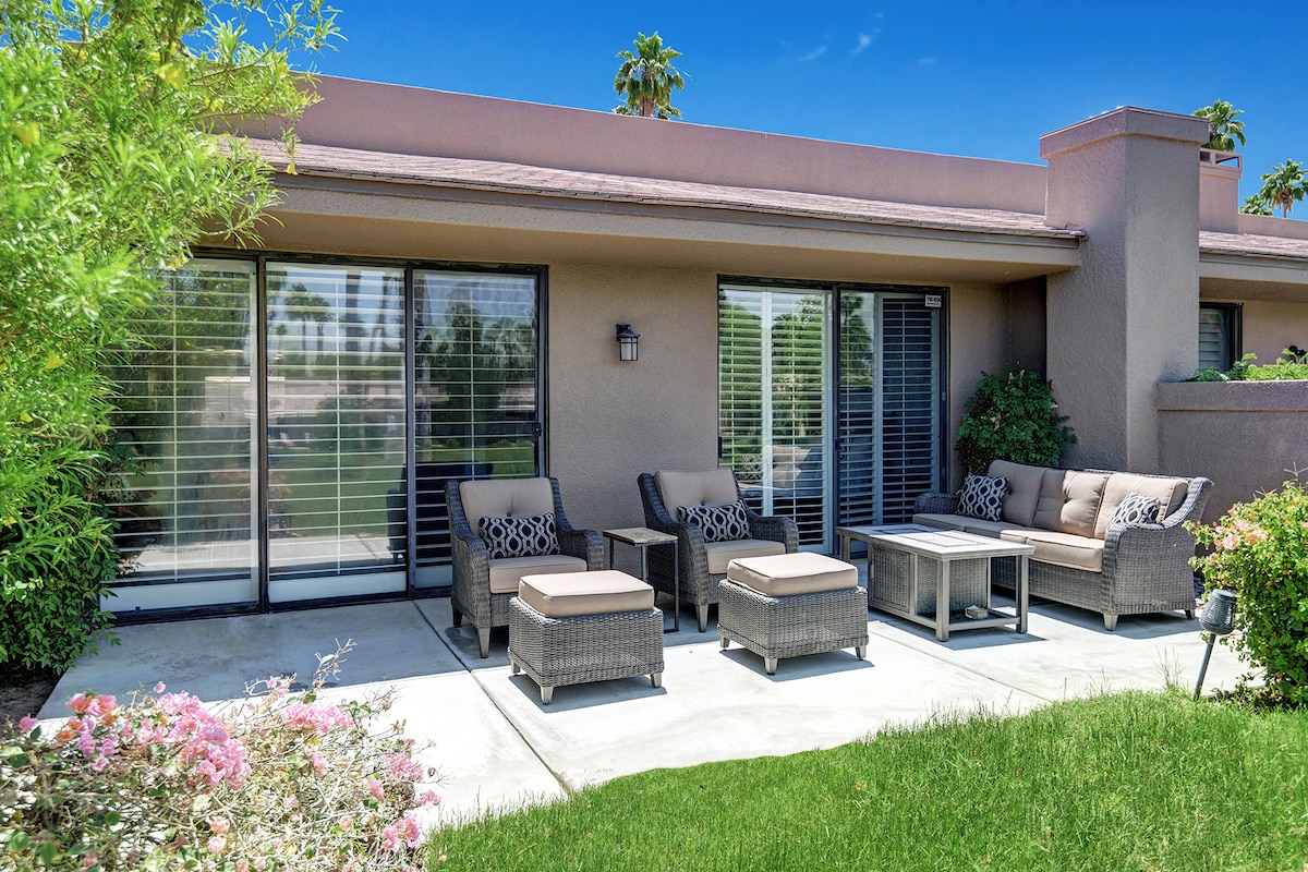 Step outside to your private patio, where plush seating and a manicured lawn invite leisurely afternoons under sunny skies and swaying palm trees.