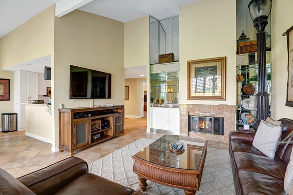 Settle into your inviting living room where rich leather seating surrounds a cozy fireplace. Warm wood accents and high ceilings create an airy yet intimate retreat, perfect for unwinding after your adventures.