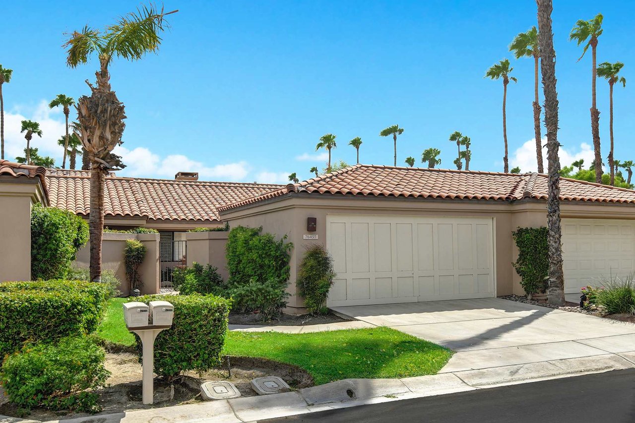 This well-maintained property welcomes you with its red-tiled roof and lush landscaping, set among swaying palms. Ample parking and a private garage await your arrival.