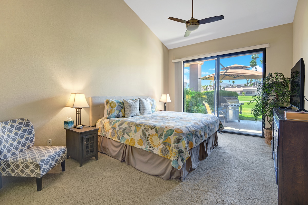 Wake up to sunshine streaming through your private patio doors, where a cozy bed and peaceful retreat await. Step outside to your own BBQ area and lush lawn—perfect for morning coffee or evening relaxation under the desert sky.