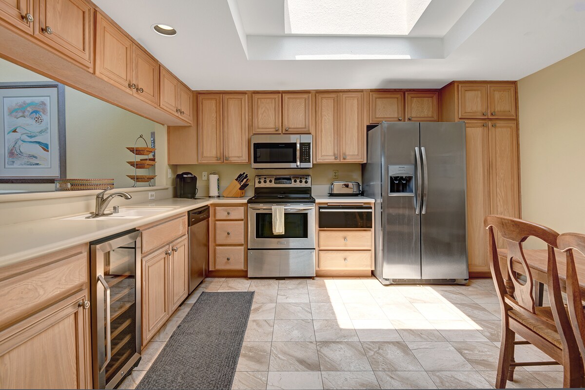 Your fully equipped kitchen has everything you need—stainless steel appliances, ample counter space, and warm wood cabinetry invite you to cook your favorite meals in comfort.