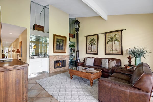 Sink into rich leather seating in this inviting living room, where vaulted ceilings and a cozy fireplace create the perfect retreat after your coastal adventures.