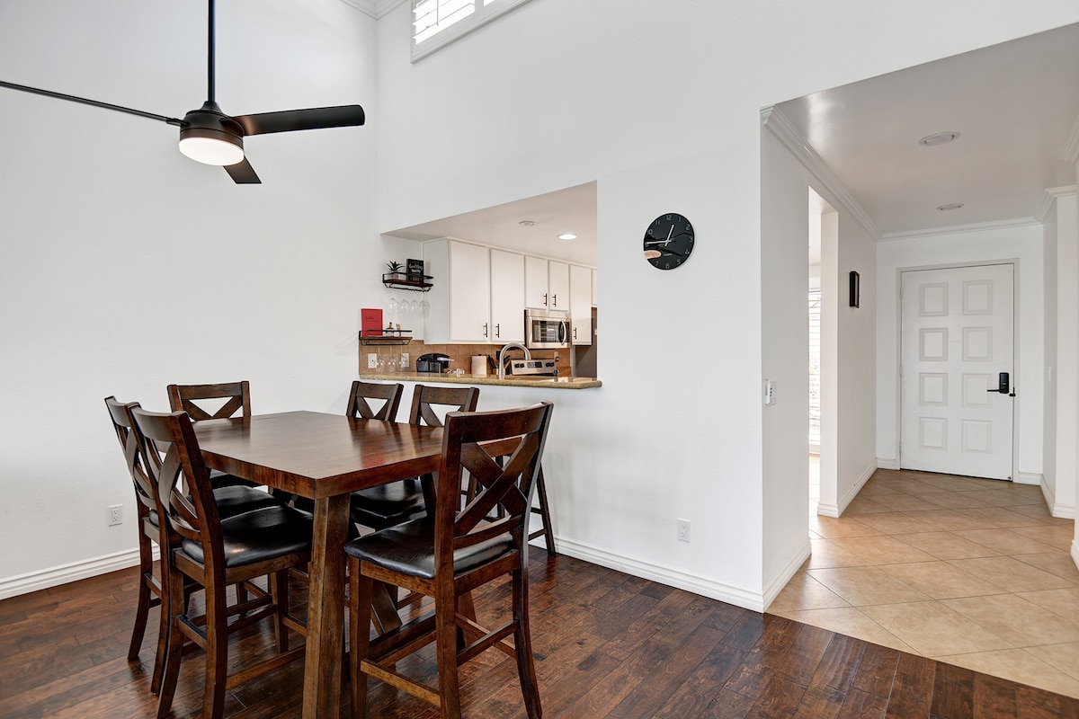 Step into a bright, open-concept space where dining and cooking flow together effortlessly. The inviting dining table is ready for meals and conversations, while your fully equipped kitchen stands just beyond.