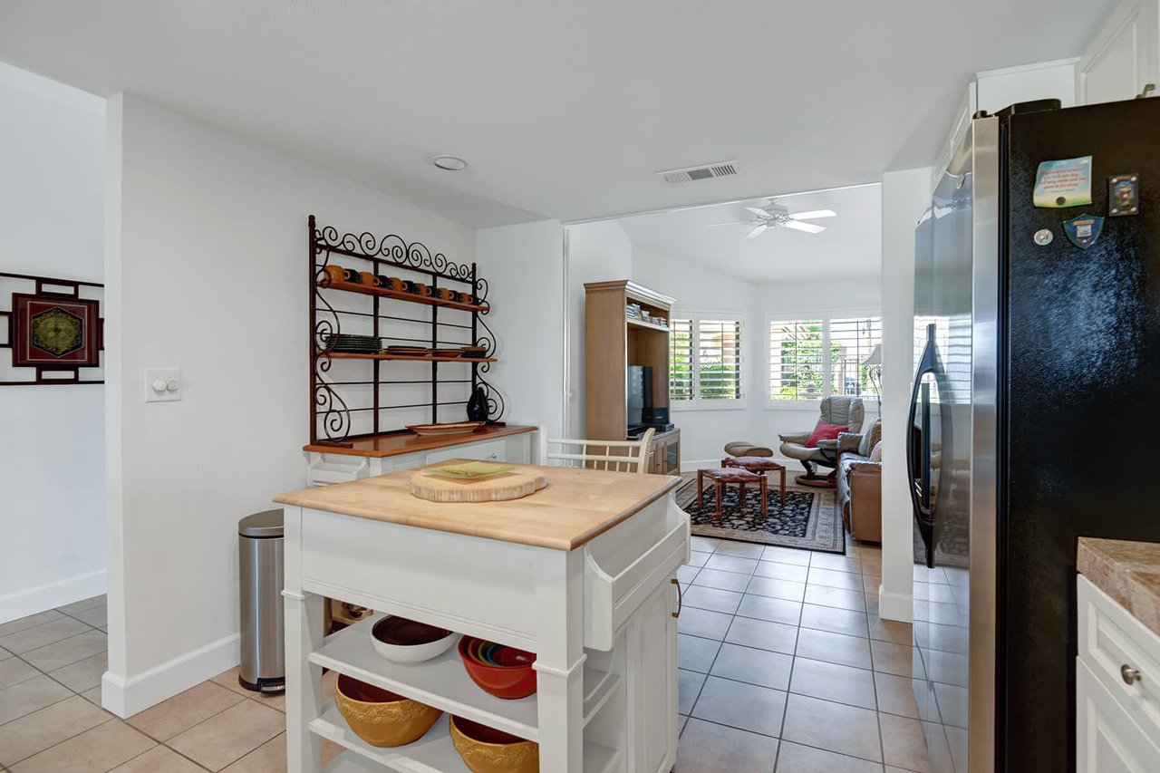 Bright, open kitchen flows into a cozy living room with natural light pouring through plantation shutters. Gather around the butcher-block island for meals and coffee before your next adventure.