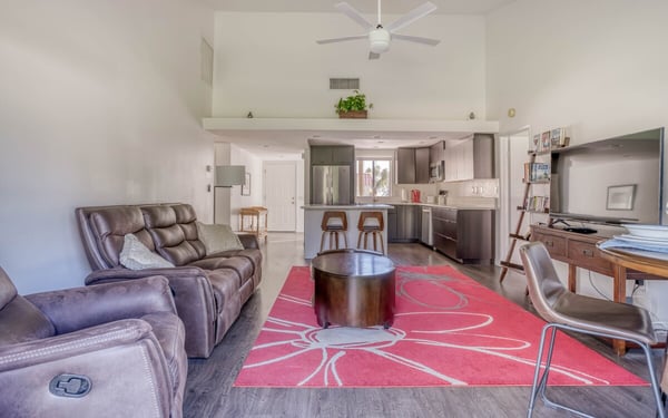 Your open-concept retreat invites you to relax in comfort with vaulted ceilings, modern furnishings, and a fully equipped kitchen ready for your vacation meals.