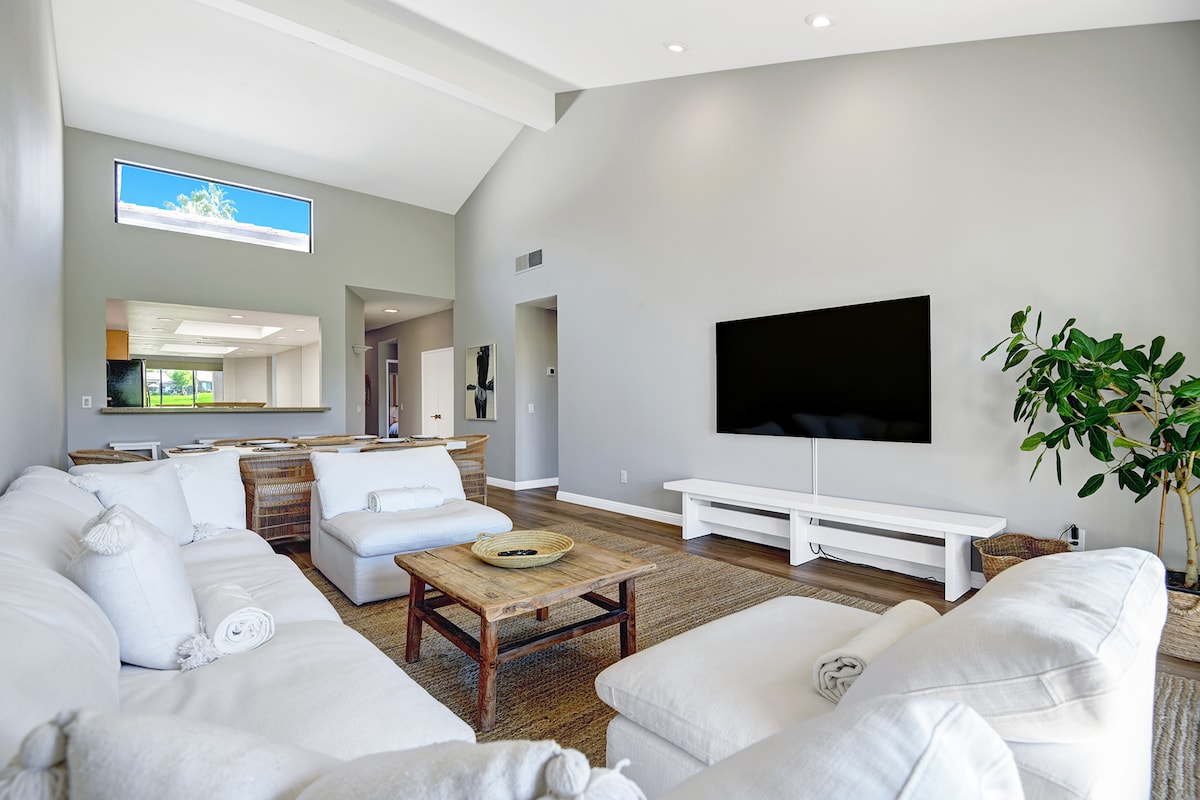 Unwind in your light-filled living space, where soaring vaulted ceilings and plush seating create the perfect backdrop for movie nights or quiet afternoons with loved ones.