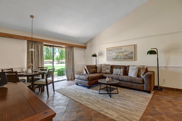 Settle into your open-plan living space with plush leather seating, warm wood accents, and garden views—perfect for unwinding after a day of adventure.
