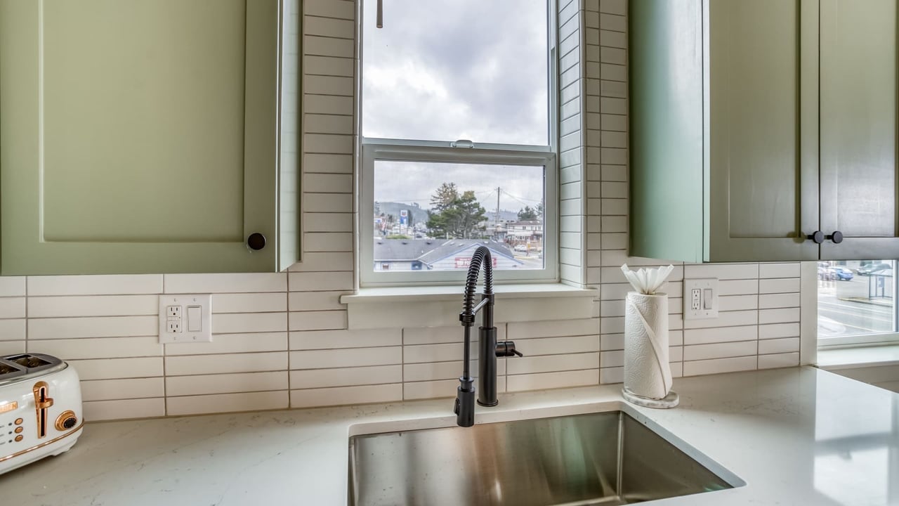 A charming kitchen where you can prepare meals while enjoying natural light streaming through the window. The sleek sink and modern fixtures make cooking feel effortless.